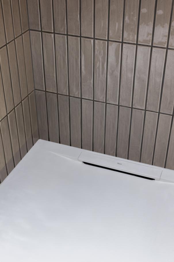 The Ona wall-hung Roca Rimless® toilet and Fineceramic® basin were chosen for their functional design and innovative technology. The toilet enhances hygiene and space efficiency, while the Fineceramic® basin offers durability and sophisticated design. The Pyros Stonex® shower tray with its ultra-thin profile and discreet linear drain contributes to the neat aesthetic. This partnership exemplifies how thoughtful design and cutting-edge technology can enhance historic spaces, creating a timeless synergy between Victorian elegance and contemporary comfort.5